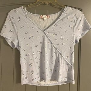 Cute summer flower top. It is brand new without the tags. It is light blue